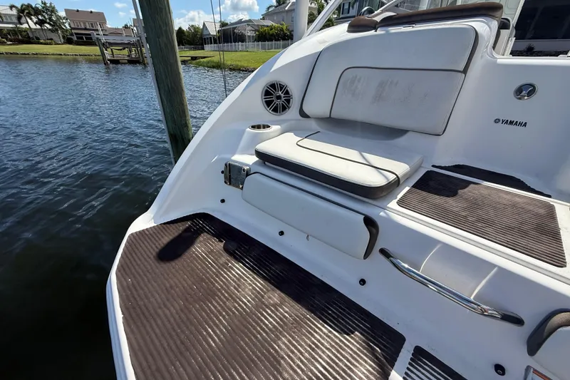 Slide: The Image of 2014 Yamaha Boats 242 Limited S, rear seating area by the water. - 5