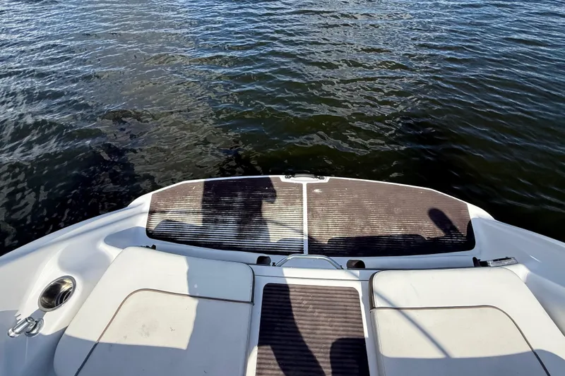Slide: The Image of 2014 Yamaha Boats 242 Limited S swim platform on water. - 53