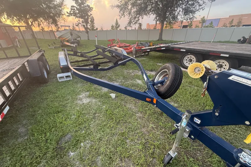 Slide: The Image of Trailer for 2014 Yamaha Boats 242 Limited S on grassy area at sunset. - 55