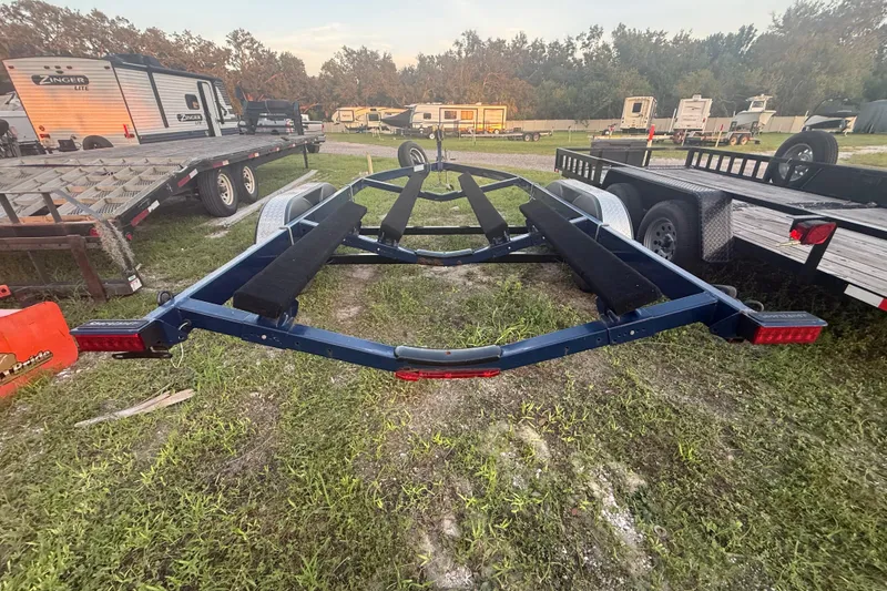 Slide: The Image of Trailer for 2014 Yamaha Boats 242 Limited S, parked on grassy area with other trailers. - 57