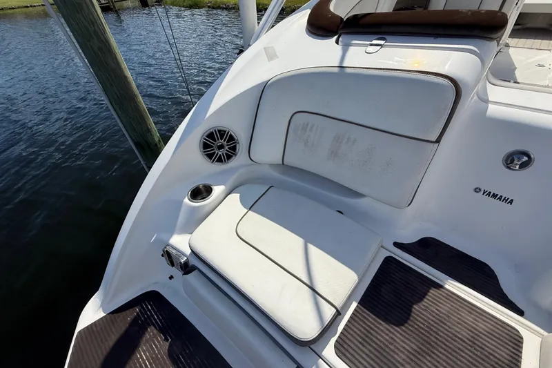 Slide: The Image of 2014 Yamaha Boats 242 Limited S interior seating with speaker and cup holder. - 6
