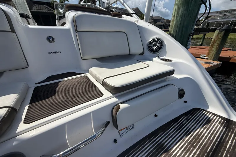 Slide: The Image of 2014 Yamaha Boats 242 Limited S interior with cushioned seating and speaker system. - 8