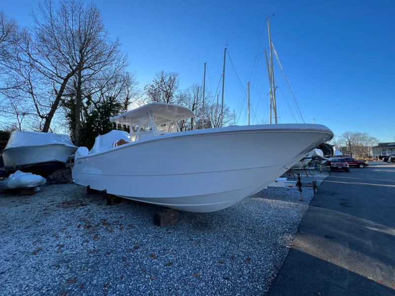 The Image of 2025 Invincible 33 Catamaran boat on gravel lot with clear blue sky. - 0