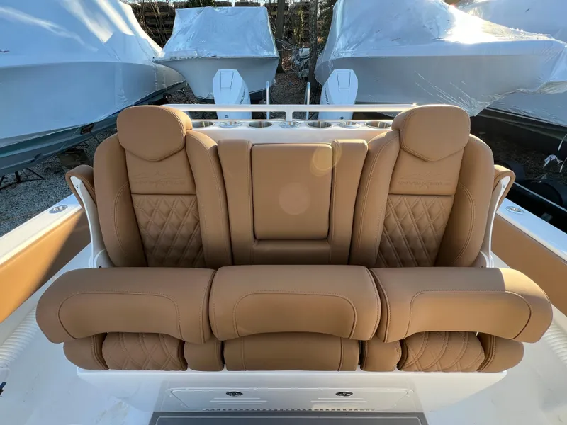 Slide: The Image of 2025 Invincible 33 Catamaran with luxurious tan leather seating. - 11