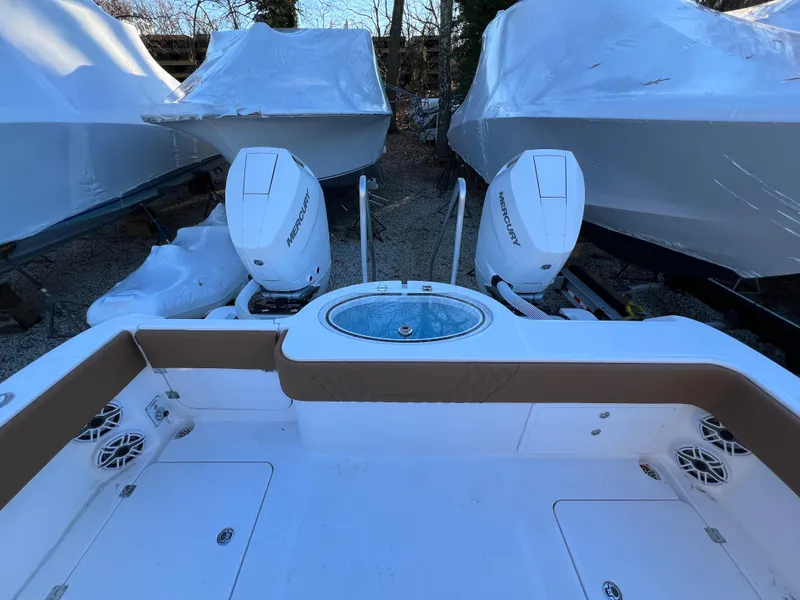 Slide: The Image of 2025 Invincible 33 Catamaran with twin outboard engines in storage. - 15