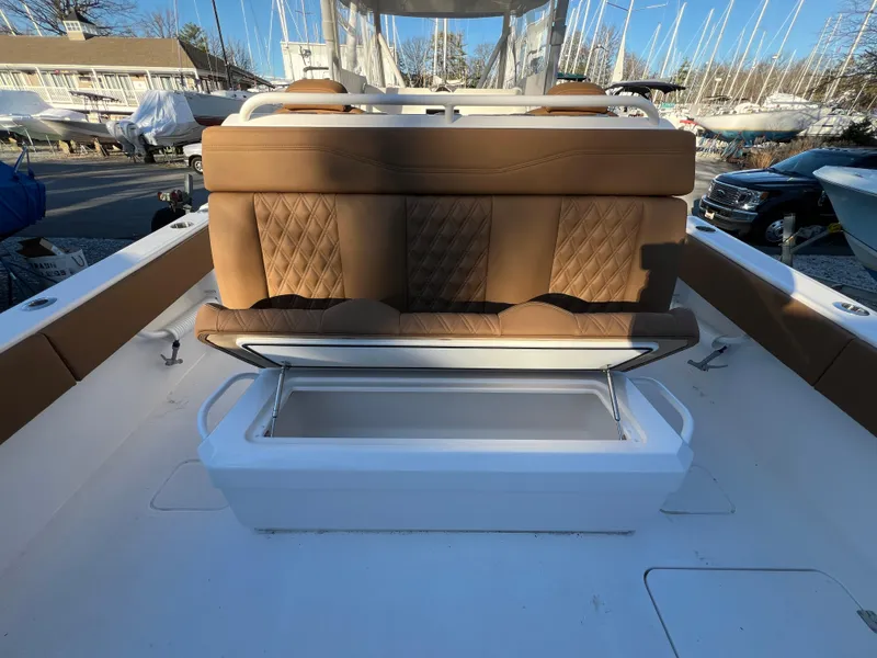 Slide: The Image of 2025 Invincible 33 Catamaran with tan seating and storage compartment. - 14