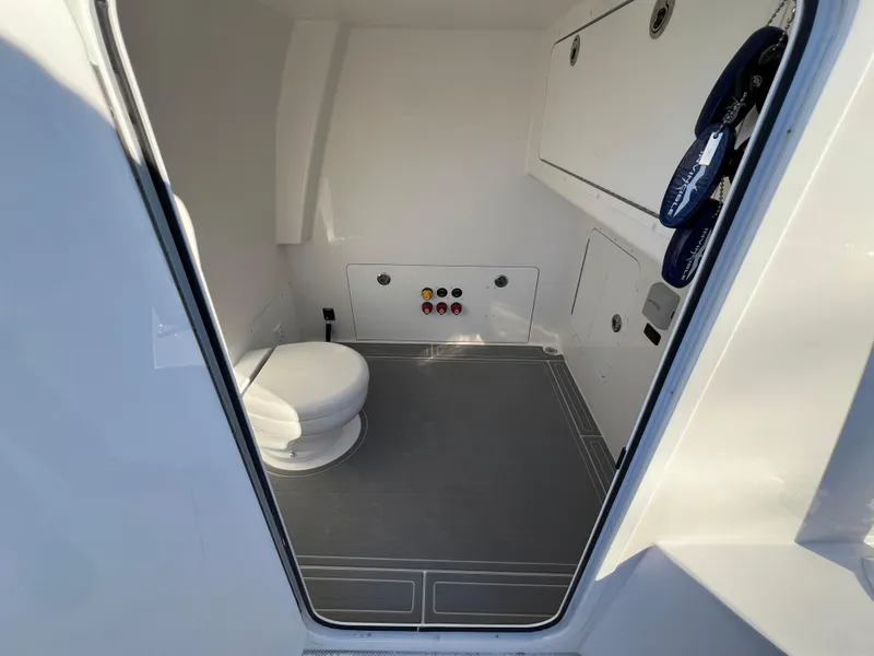 Slide: The Image of Interior of 2025 Invincible 33 Catamaran showing a clean, modern marine toilet. - 9