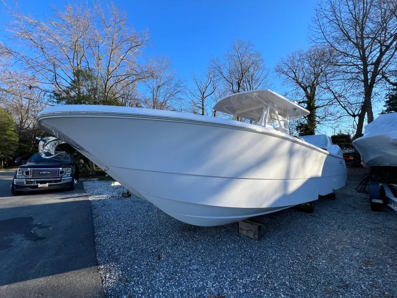 Slide: The Image of 2025 Invincible 33 Catamaran boat on display in outdoor setting. - 2