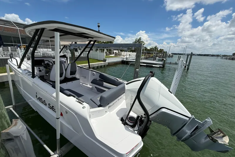 Slide: The Image of 2023 Axopar 25 Cross Top boat docked by the water on a sunny day. - 13