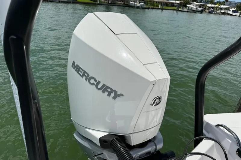 Slide: The Image of Outboard motor on 2023 Axopar 25 Cross Top boat, docked on calm water. - 18