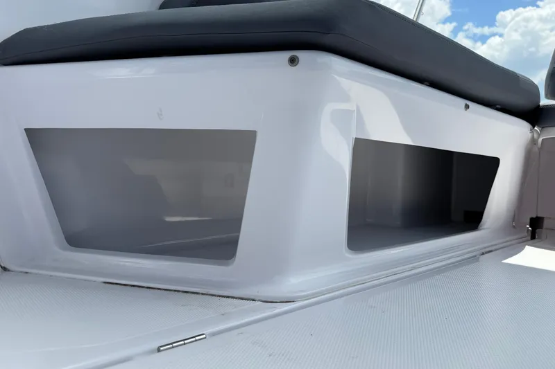 Slide: The Image of 2023 Axopar 25 Cross Top boat seating with storage compartments, featuring sleek design. - 23