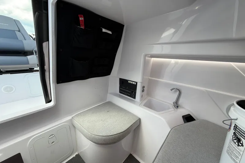 Slide: The Image of 2023 Axopar 25 Cross Top interior with seating, sink, and control panel. - 43