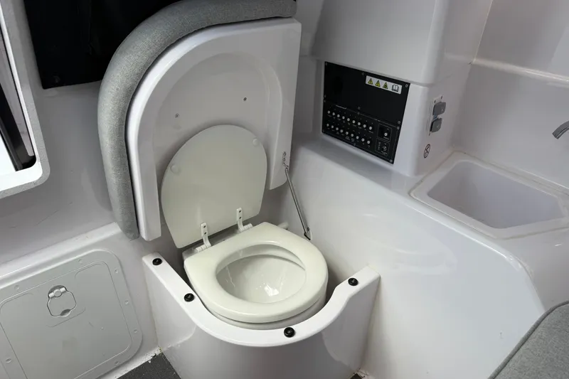 Slide: The Image of 2023 Axopar 25 Cross Top boat interior with compact toilet and sink. - 45