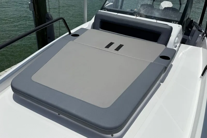Slide: The Image of 2023 Axopar 25 Cross Top boat with cushioned seating area on deck. - 47