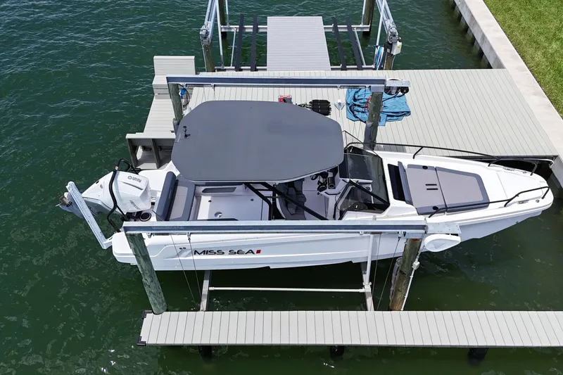 Slide: The Image of 2023 Axopar 25 Cross Top boat docked on water, aerial view. - 7