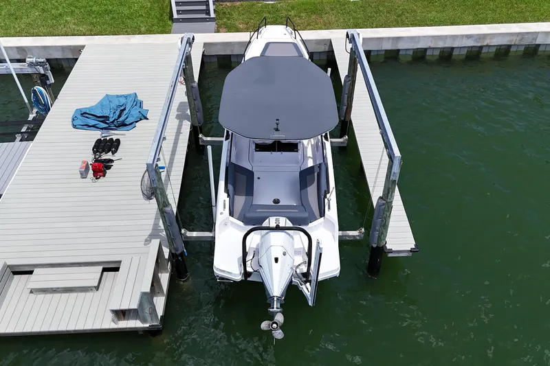 Slide: The Image of 2023 Axopar 25 Cross Top boat docked at marina, aerial view. - 8