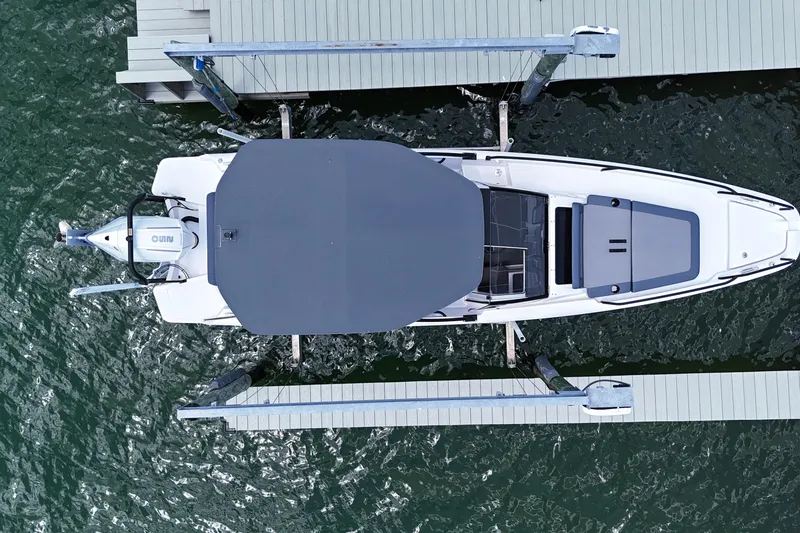 Slide: The Image of Overhead view of 2023 Axopar 25 Cross Top docked on water. - 9