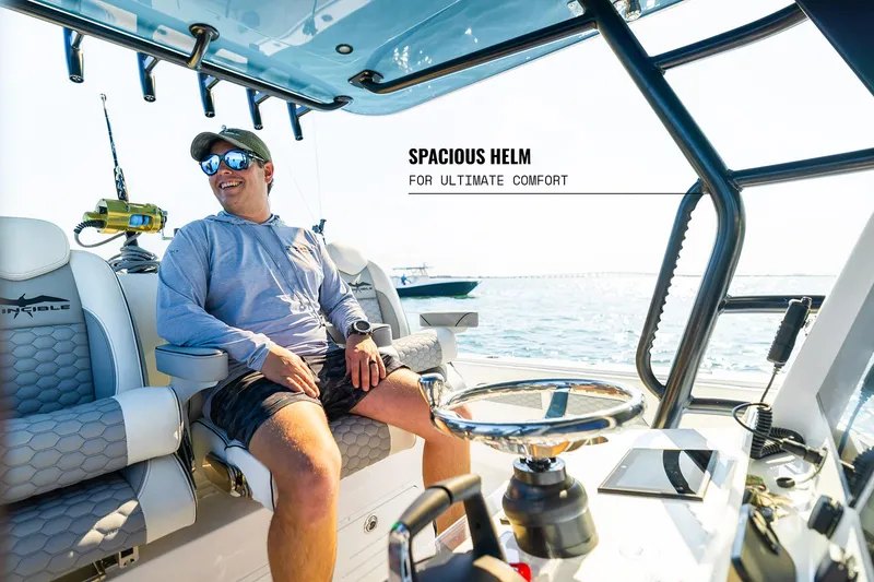 Slide: The Image of Man relaxing at helm of 2025 Invincible 36 Catamaran, showcasing spacious design and comfort. - 20