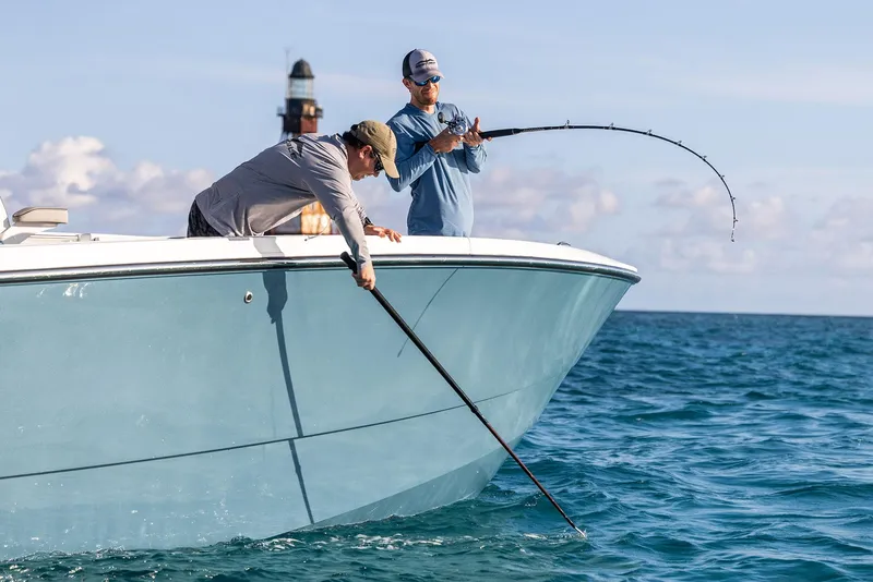 Slide: The Image of Two people fishing on a 2025 Invincible 36 Catamaran in open water. - 6