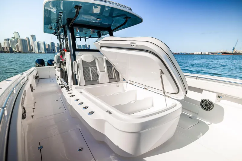 Slide: The Image of 2025 Invincible 36 Catamaran with open storage, sleek design, and city skyline backdrop. - 7