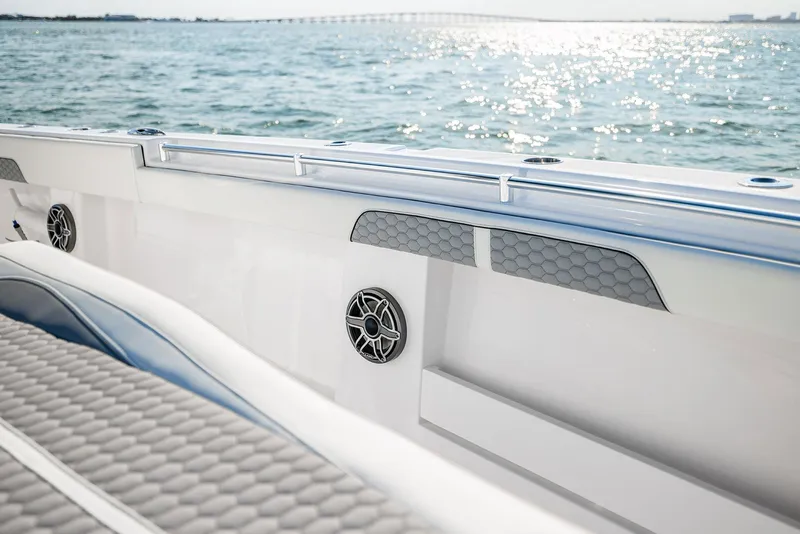 Slide: The Image of 2025 Invincible 36 Catamaran interior with ocean view, featuring sleek design and modern speakers. - 8