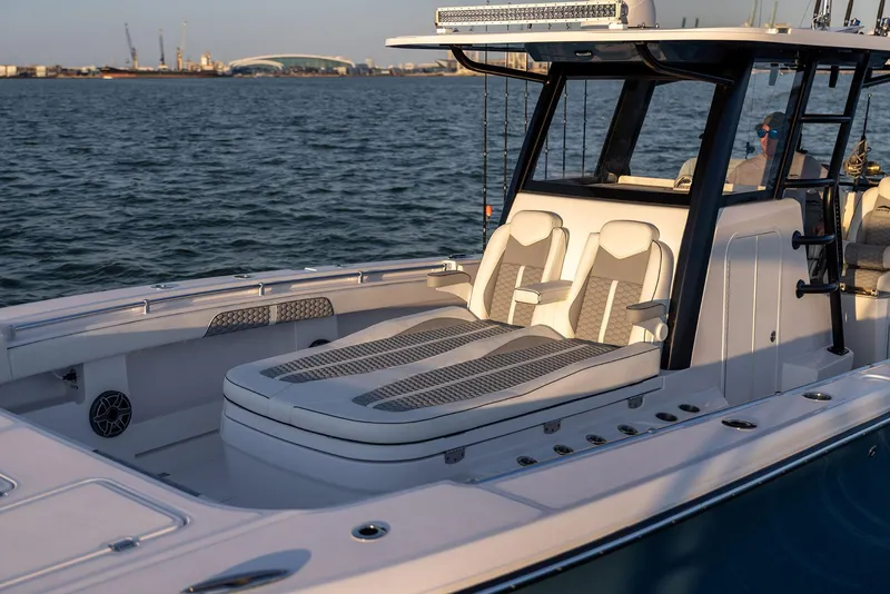 Slide: The Image of 2025 Invincible 36 Catamaran with sleek seating, docked on calm waters. - 9