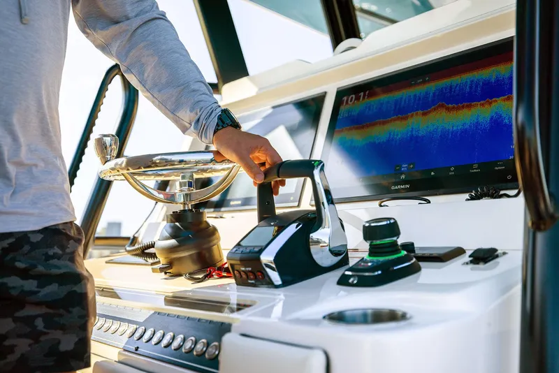Slide: The Image of 2025 Invincible 36 Catamaran helm with advanced navigation controls and display screen. - 11