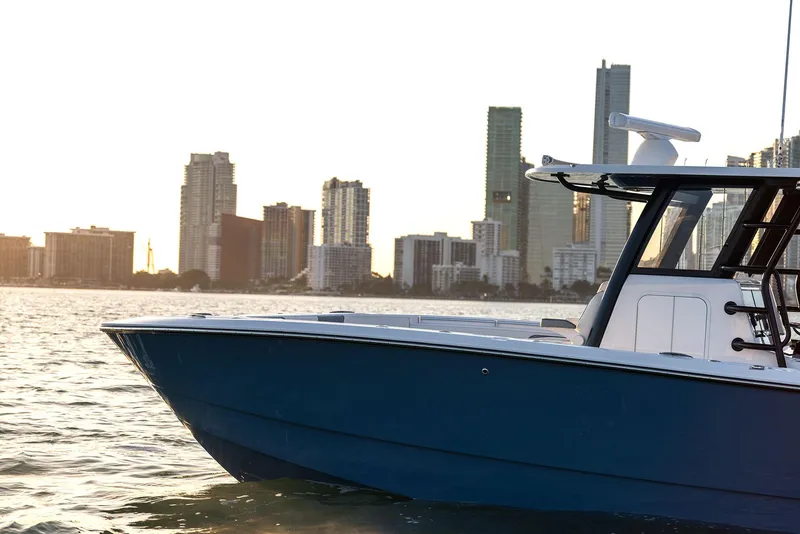 Slide: The Image of 2025 Invincible 36 Catamaran on water with city skyline in background. - 3
