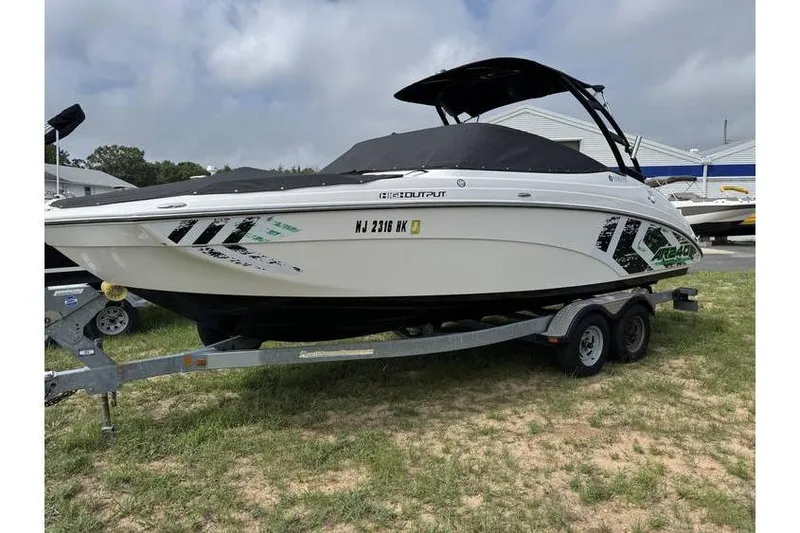 Slide: The Image of 2016 Yamaha AR240 boat on trailer, covered and parked on grass. - 15