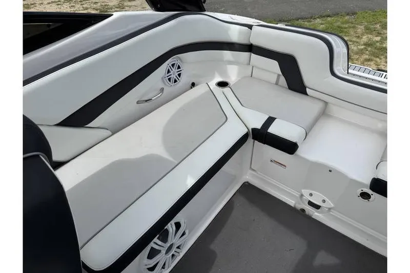 Slide: The Image of 2016 Yamaha AR240 boat interior with white seating and speaker system. - 8