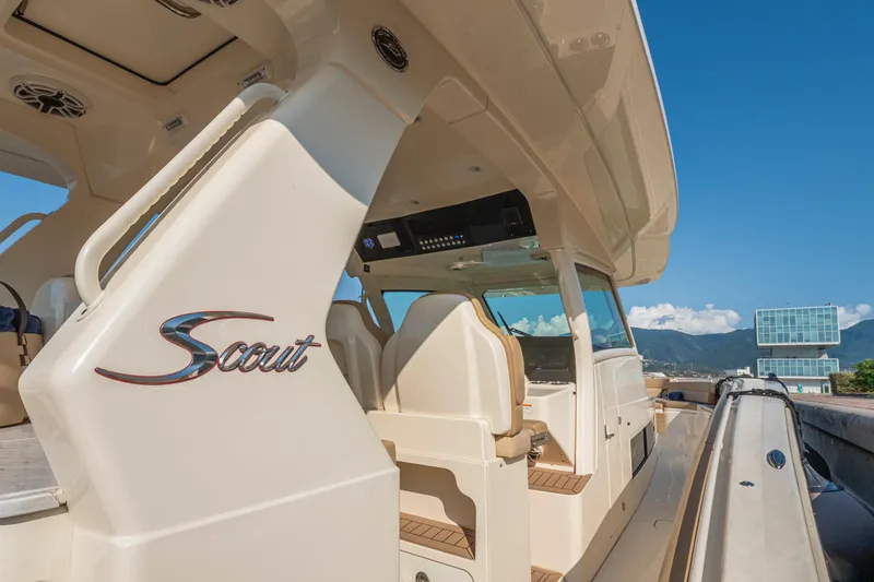 Slide: The Image of 2023 Scout 425 LXF boat with dual Mercury outboard engines at a dock. - 15