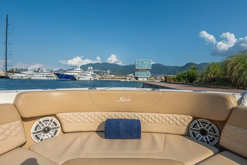 Slide: The Image of Luxurious 2023 Scout 425 LXF boat with spacious seating, docked in a scenic marina. - 23