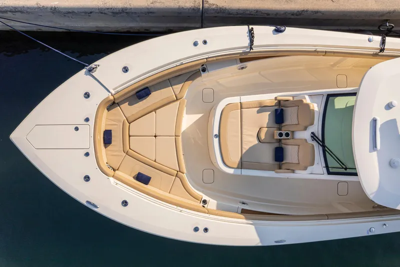 Slide: The Image of 2023 Scout 425 LXF luxury boat docked at marina, featuring spacious seating and modern design. - 26