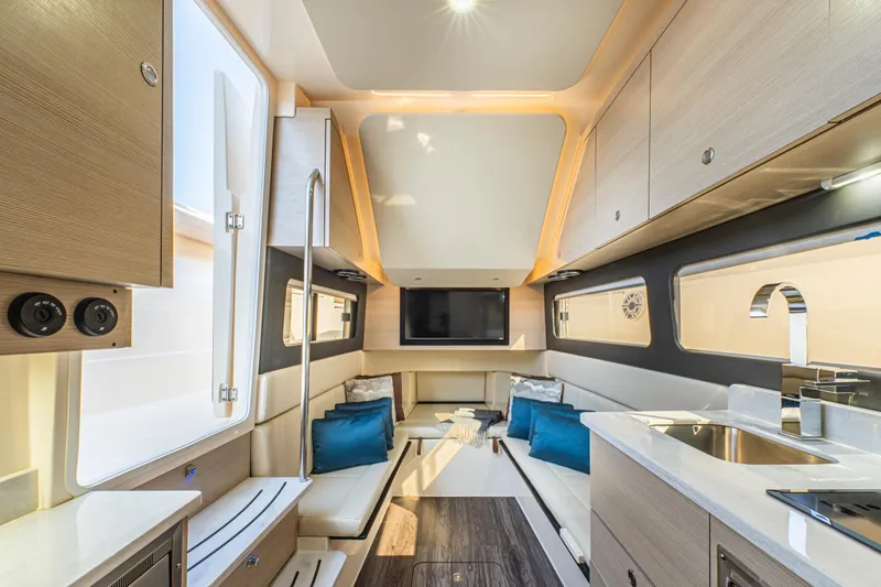 Slide: The Image of 2023 Scout 425 LXF luxury boat docked with scenic mountain backdrop. - 28