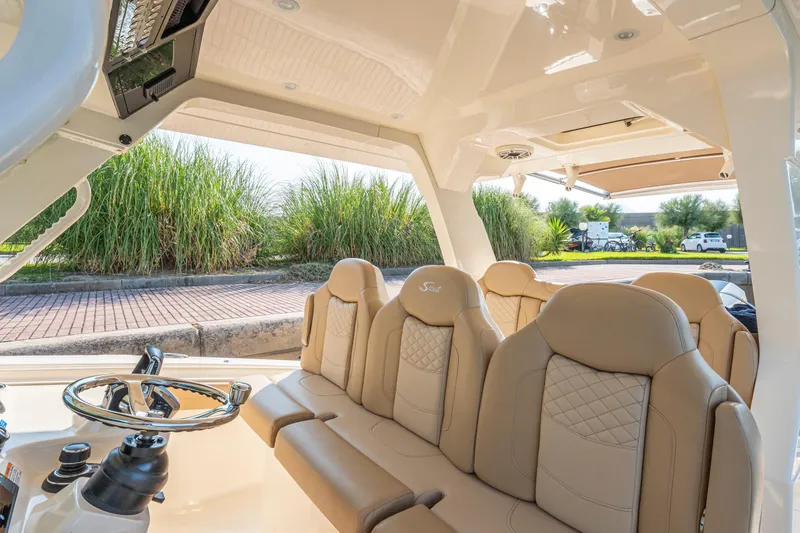 Slide: The Image of 2023 Scout 425 LXF boat docked, featuring spacious seating and sleek design. - 8