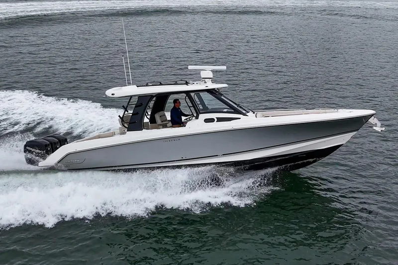 Slide: The Image of 2022 Boston Whaler 350 Realm cruising on open water, side view. - 10
