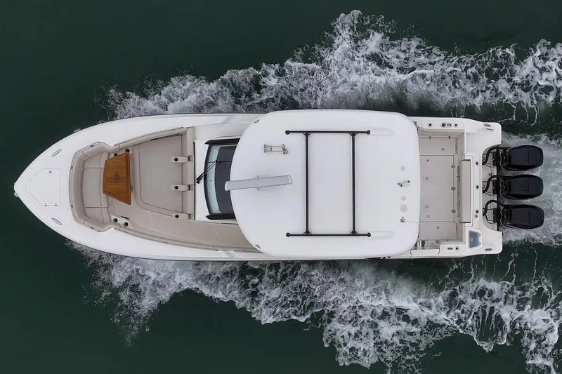 Slide: The Image of Aerial view of 2022 Boston Whaler 350 Realm boat cruising on water. - 16