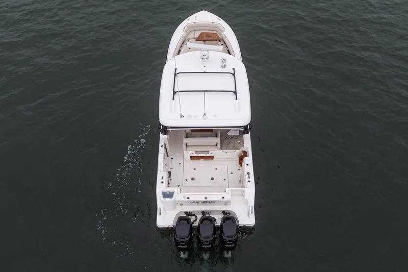 Slide: The Image of 2022 Boston Whaler 350 Realm boat on water, aerial rear view. - 17