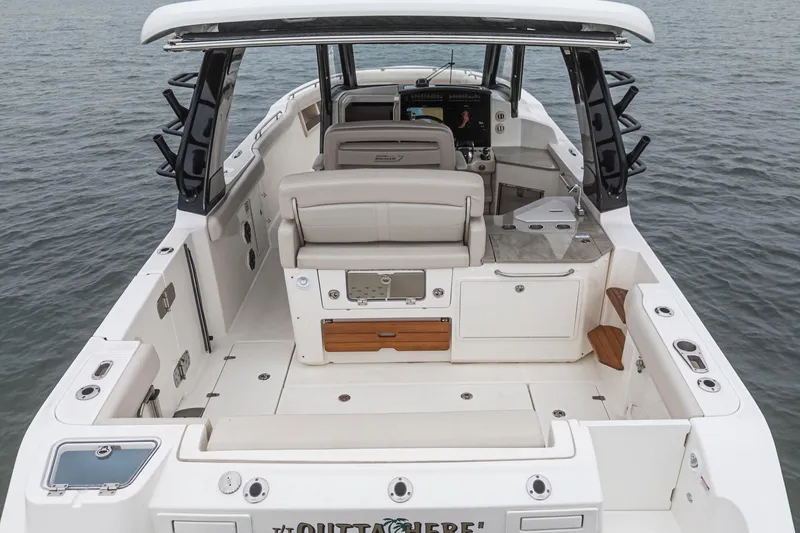 Slide: The Image of 2022 Boston Whaler 350 Realm boat interior with seating and helm, on water. - 20