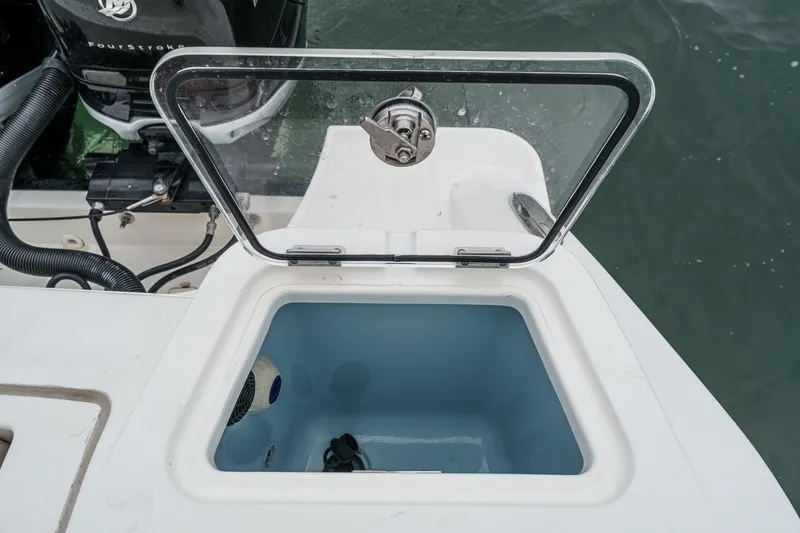 Slide: The Image of Open storage compartment on 2022 Boston Whaler 350 Realm boat, near water. - 23