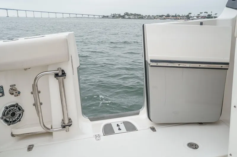 Slide: The Image of Boston Whaler 350 Realm 2022 boat with open side door, ocean view. - 25