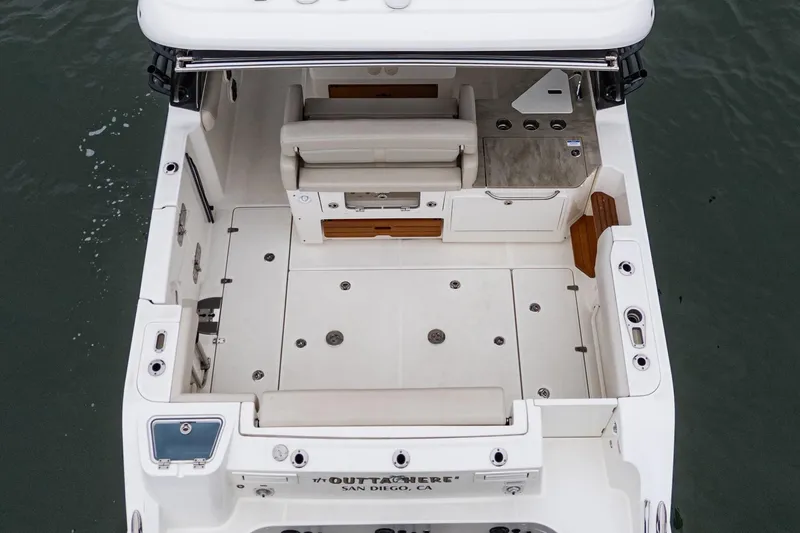 Slide: The Image of 2022 Boston Whaler 350 Realm boat interior, featuring spacious deck and seating area. - 27