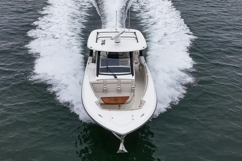 Slide: The Image of 2022 Boston Whaler 350 Realm cruising on open water, aerial view. - 3