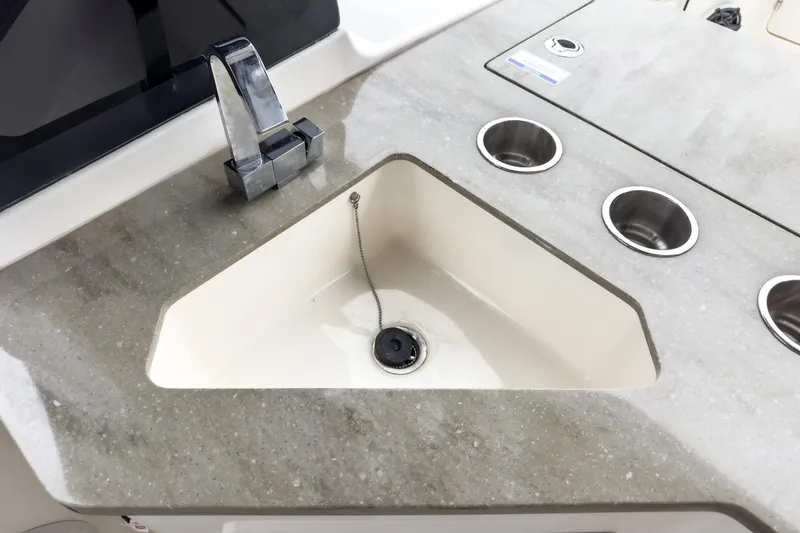 Slide: The Image of Boston Whaler 350 Realm 2022 boat sink with modern faucet and cup holders. - 34