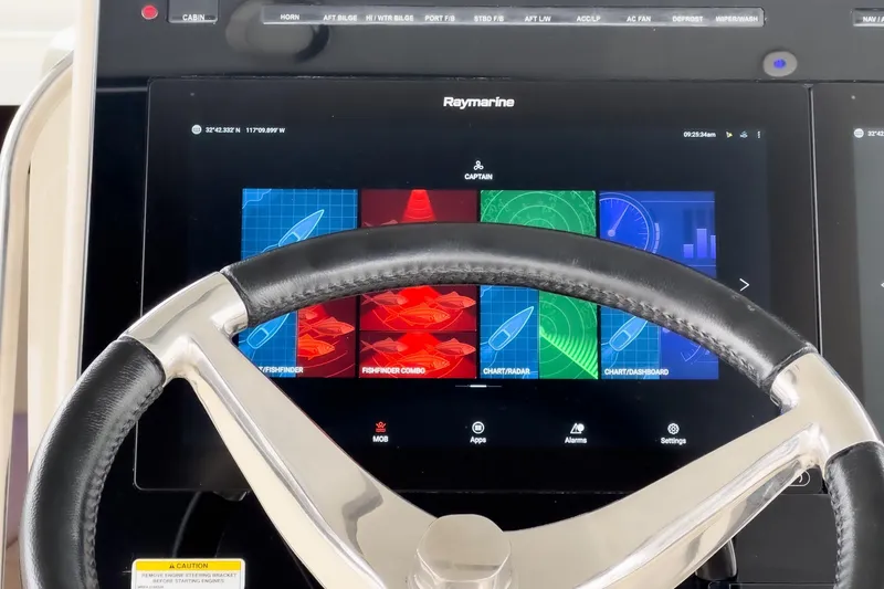 Slide: The Image of Steering wheel and Raymarine display on 2022 Boston Whaler 350 Realm boat. - 41