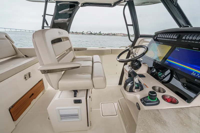 Slide: The Image of 2022 Boston Whaler 350 Realm helm with advanced navigation displays and comfortable seating. - 53