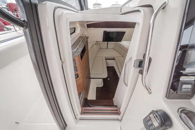 Slide: The Image of Interior cabin of 2022 Boston Whaler 350 Realm, featuring seating and modern amenities. - 57