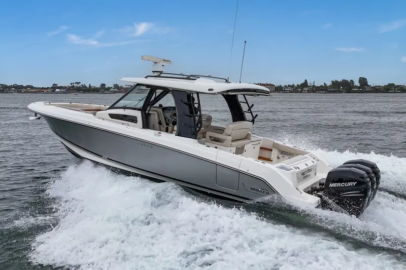 Slide: The Image of 2022 Boston Whaler 350 Realm cruising on water with powerful Mercury engines. - 6