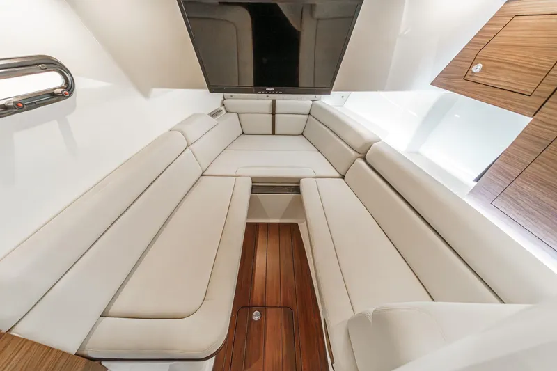 Slide: The Image of Luxurious interior of 2022 Boston Whaler 350 Realm with plush seating and wood flooring. - 60