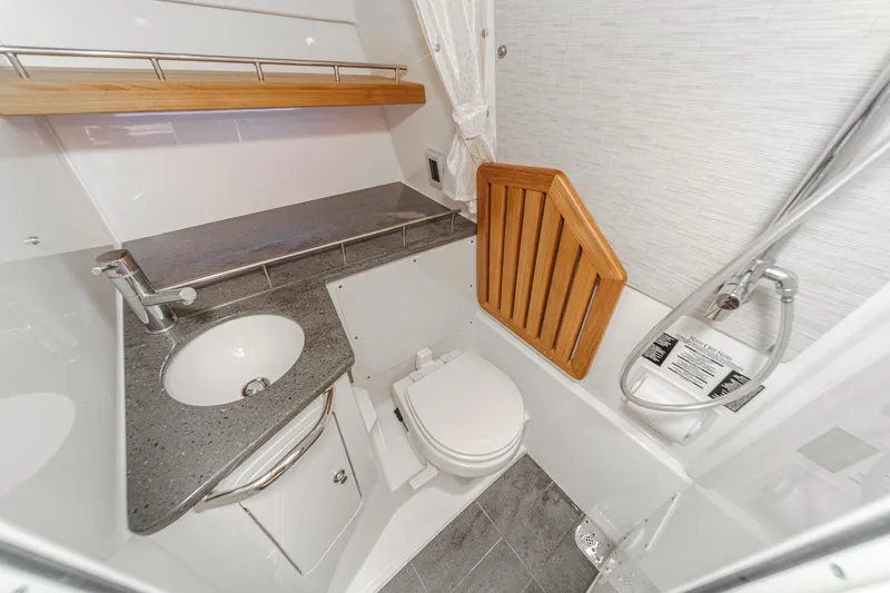 Slide: The Image of 2022 Boston Whaler 350 Realm boat bathroom with sink, toilet, and shower. - 65